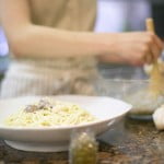 Young Woman Preparing Noodles --- Image by © Royalty-Free/Corbis